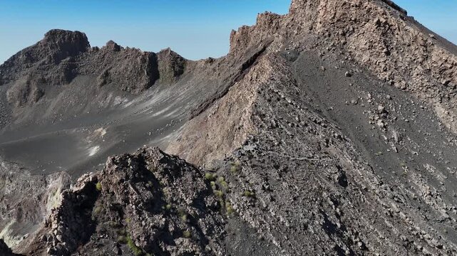 aerial drone shot of the steep, dark volcanic slopes and ash fields of the Pico do Fogo summit on Fogo Island, Cabo Verde