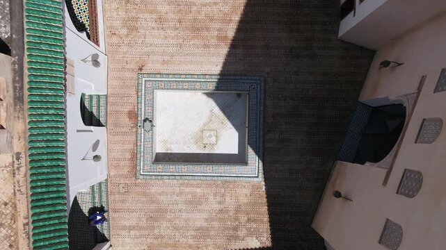 Top down aerial drone view of traditional Moroccan courtyard with geometric layout and green tiled rooftops in Fez Morocco ideal for cultural projects