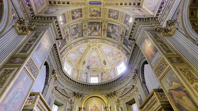 Low angle view of the magnificent ornate golden coffered ceiling and the main altar inside the Church of San Marcello al Corso
