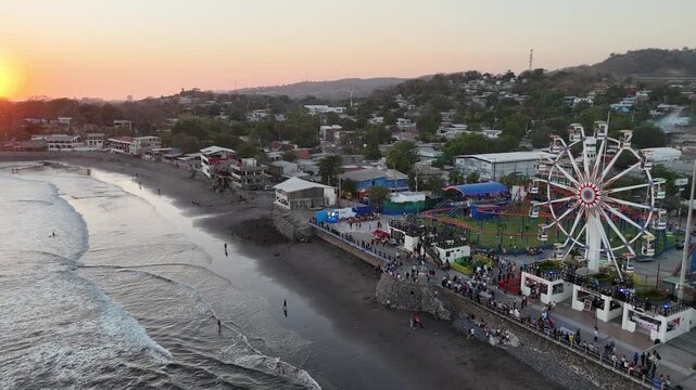 Drone view of Oceanfront amusement park located at Puerto de La Libertad, El Salvador, during colorful sunset