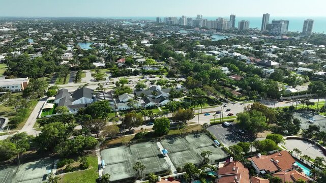A serene aerial glimpse of Naples United Church of Christ, where modern Floridian architecture meets the quiet rhythm of palm-lined streets and coastal sunshine.