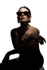 Fototapeta premium Woman in black sunglasses posing in dramatic shadow with elegant jewelry. Concept of eyewear fashion ad, luxury accessory campaign, bold beauty editorial and modern style branding.