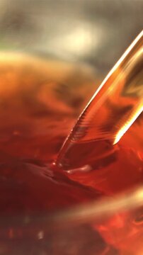 Super slow motion black tea is poured into the cup. Macro background.Filmed on a high-speed camera at 1000 fps.