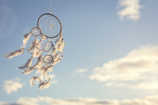 Dream catcher charm background at sunset with copy space