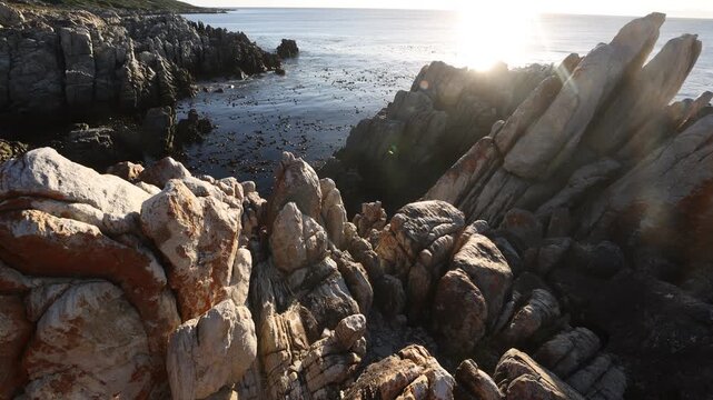 rocky coastline of DeKelders, Gansbaai, South Africa at sunset