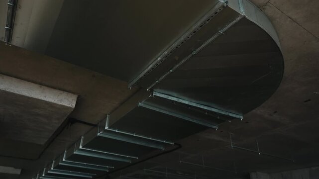 Industrial ventilation duct system installed on concrete ceiling close up