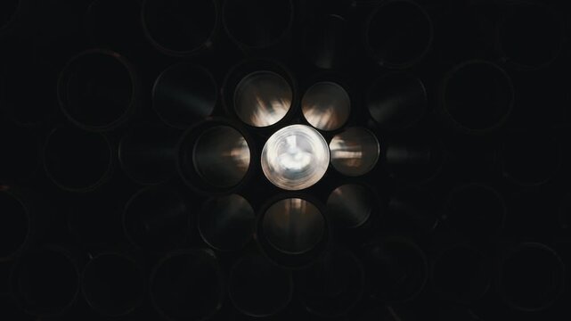 Stacked plastic pipes viewed from inside circular openings close up
