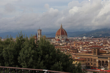 Obraz premium Florence cityscape with Duomo and Bargello tower, Arno river reflecting warm sunset light