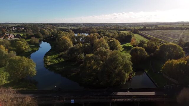 Aerial View of Winding River Nene Through Lush Trees in English Countryside Thrapston