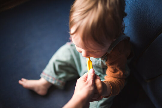 High angle view of unrecognizable person feeding boy with spoon in train