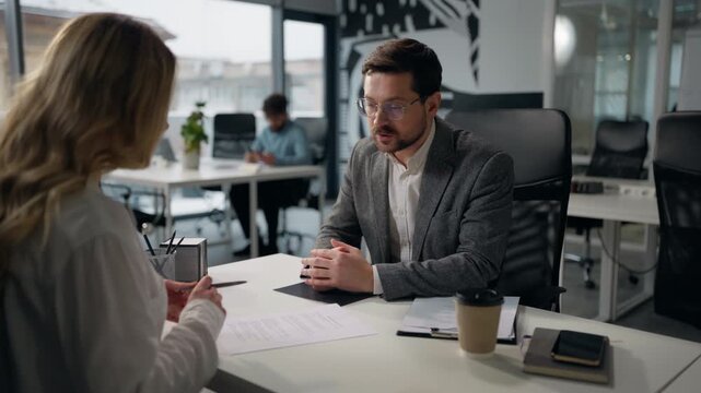 Caucasian businessman insurance agent give woman client business paper businesswoman signing document in office at table two colleagues man boss giving offer to female intern write signature contract