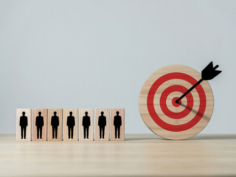 Business target audience concept with wooden target and people icons on desk