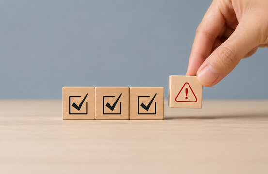 Problem and error warning concept. Wooden cubes with triangle caution warning sign, warning system for notification error and maintenance. Incident, risk, contingency management. Proactive approach 