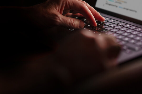 Male freelancer typing mail on laptop