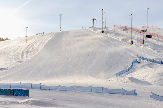 Tranquil view of snow covered ski slope against sky in winter