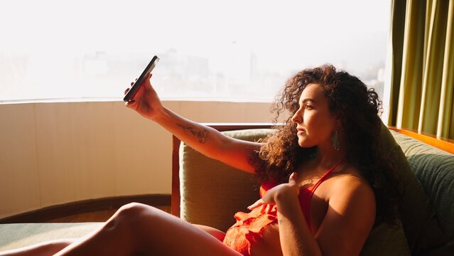 Young woman creating content and sharing a moment of leisure with her phone
