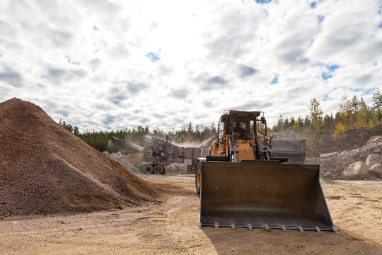Excavation vehicle at construction site under cloudy sky