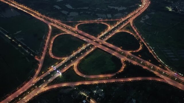 Night aerial drone video perspective of illuminated Ring Road 2 and National Highway 5 interchange in Dong Anh District.