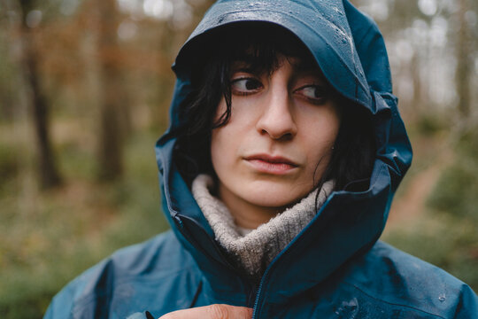 Contemplative woman wearing raincoat looking away