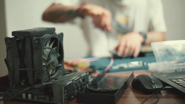 Man repairs computer parts at home from morning to afternoon