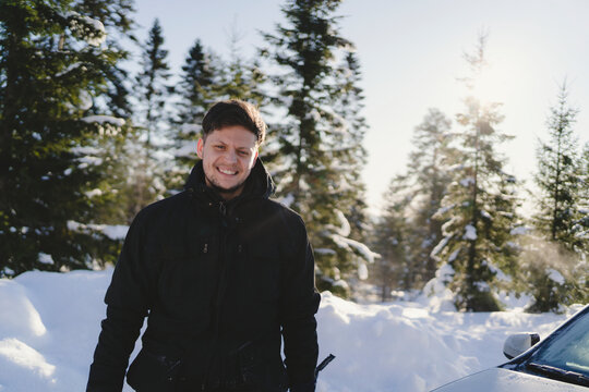 Portrait of smiling man in winter forest