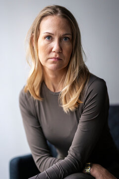 Portrait of mature businesswoman with blond hair sitting in office