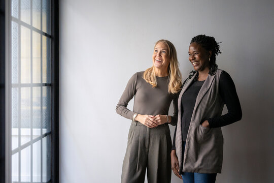 Happy multiracial female business coworkers spending leisure time in office
