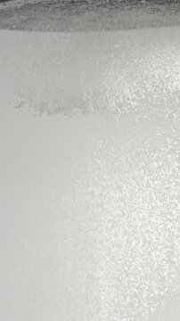 Super slow motion baking flour sift through a sieve. On a white background. Filmed on a high-speed camera at 1000 fps.