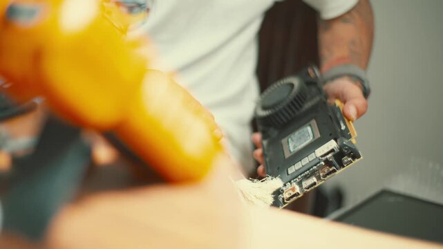 Cleaning a computer part using a brush for maintenance in a home workspace