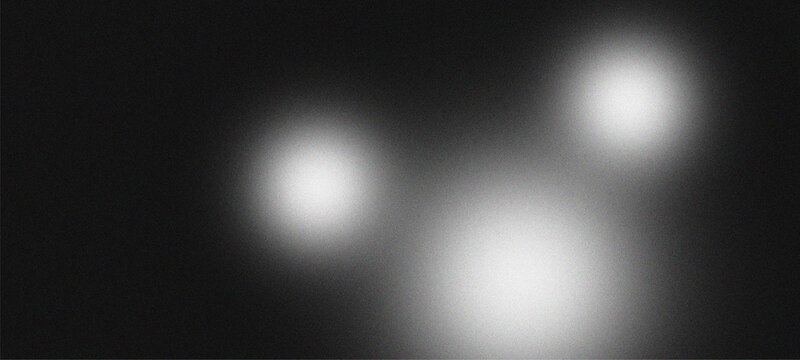 Abstract Grainy Noise Background with Blurred White Light Orbs