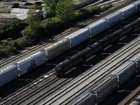 Aerial view of freight trains with tanker and hopper cars on parallel tracks in a rail yard Cincinnati, OH, United States.