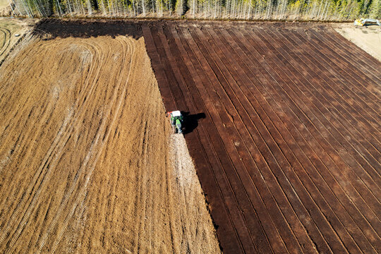 Drone view of tractor working in field at sunny day
