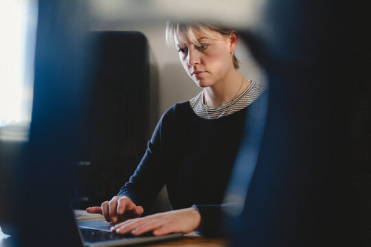 Businesswoman working on laptop at home