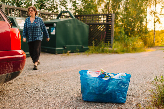 Bag full of plastic garbage on roadside near garbage dump
