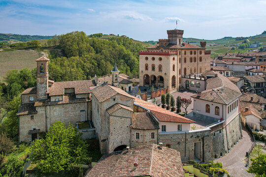 Aerial view of Castello Falletti di Barolo and the parish church with historic stone walls and terracotta roofs Barolo, Piedmont, Italy.