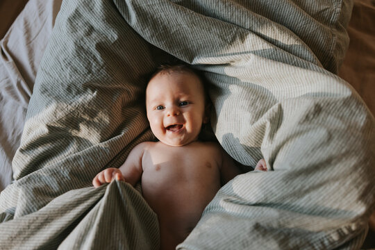 Directly above shot of cute shirtless baby boy lying down on blanket