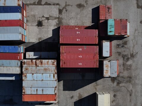 Aerial view of colorful shipping containers stacked in a logistics terminal on a concrete surface Cincinnati, OH, United States.