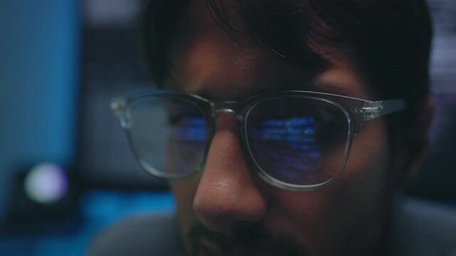 Programmer Analyzing Complex Blue Source Code with Glasses Reflection