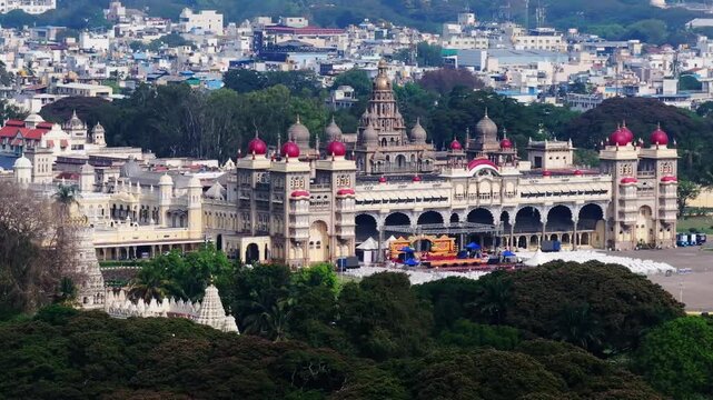 Close up shot of Amba Vilas Palace with gold plated dome and temple at Mysuru, karnataka, india. day time, push back shot, drone shot, 4k.
