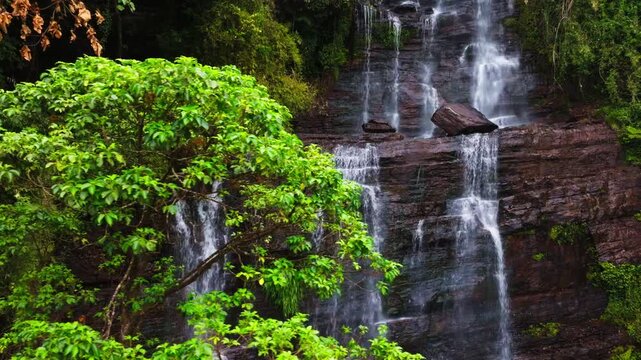 Reveal shot of Jhari Waterfall with steep rocks and dense forests at Attigundi, Dattatreya Peeta, Chikkamagaluru, Karnataka, india. day time, trucking shot, drone shot, 4k.