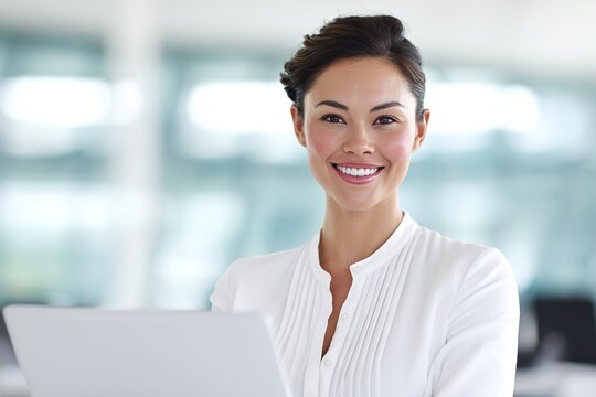 Smiling Young Woman Studying with Laptop in Modern Office