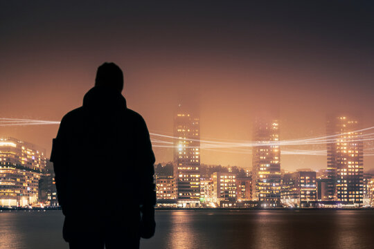 In silhouette of unrecognizable person looking at illuminated view