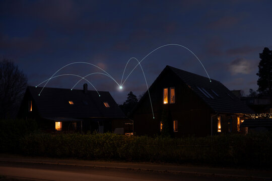 Digitally generated image of network lines connecting houses at dark night