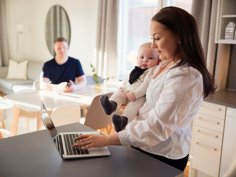 Female freelancer multi-tasking at home