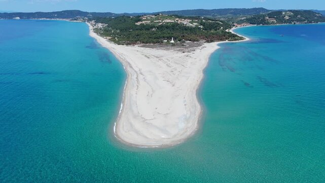 High angle aerial drone view of the spectacular Possidi Cape sandspit with its white sandy beach surrounded by crystal clear turquoise blue sea water in Halkidiki Greece
