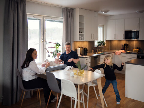 Parents spending leisure time with children at home