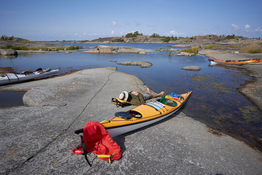 Beautiful view of kayakar sleeping on rock formation against sky at sunny day