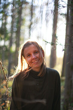 Portrait of smiling woman in forest