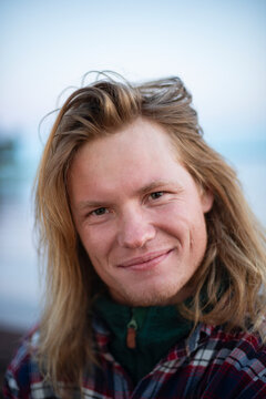 Smiling man with long blond hair