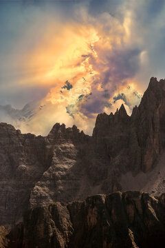 Scenic view of dramatic golden light shining through clouds over Italian Dolomites